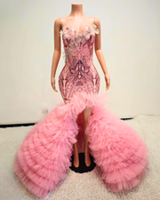 Beaded pink prom dress with rhinestone bodice and layered ruffle skirt, styled for formal events and glamorous occasions.