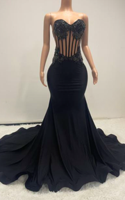 Eden black mermaid evening gown with sheer beaded corset bodice and flowing train for evening events, birthdays, or stage appearances.