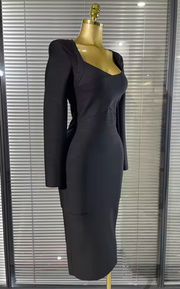 A fitted black long-sleeve midi dress with structured shoulders and a square neckline, displayed on a gold mannequin in front of window blinds.