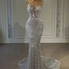 Silver crystal luxury prom dress with sparkling crystal details and elegant floor-length design.