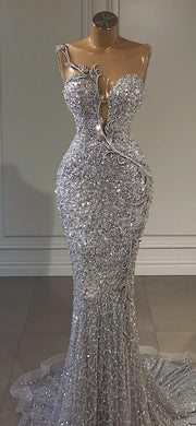 Silver crystal luxury prom dress with sparkling crystal details and elegant floor-length design.