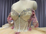 Champagne off shoulder sweetheart gown with appliqué detailing.