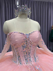 Pink quinceañera dress with corset bodice, illusion sleeves, and princess silhouette skirt.