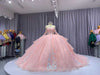 Pink quinceañera dress with corset bodice, illusion sleeves, and princess silhouette skirt.