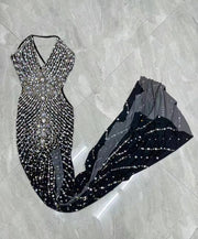 Elegant prom dress completely covered in silver rhinestones with a dramatic high split. Audre sparkling formal gown.
