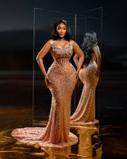 Golden beaded prom dress with luxury detailing and fitted silhouette.