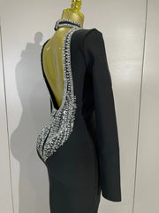 Maggie black rhinestone bandage maxi dress with long sleeves, a backless design, and a figure-hugging bodycon silhouette
