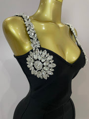 Kaylani wearing a shining diamonds V neck sleeveless jumpsuit with sparkling rhinestone details.