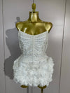 Kelsey white off-shoulder bandage mini dress with pearl chain accents and three-dimensional floral embellishments