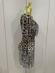 Turn heads in the Daniela leopard print rhinestone tassel mini dress. One-shoulder stretch party dress for birthdays, clubs, and special events.