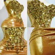 Jasmine 2-piece outfit featuring a gold glitter crystal top and matching mini skirt for drag queen performances and birthday events.