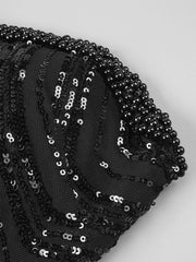 Black strapless mini dress with pearl chains, sequins, feathers, and geometric embellishments for homecoming, cocktail, and evening parties.