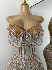 Shine in the Claren pearl and rhinestone off-the-shoulder mesh bodycon mini dress. Perfect for birthdays, parties, and special occasions.