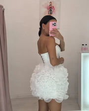 Mannequin Wearing a Stylish White Ruffled Tulle Corset Birthday Dress with Layered Skirt and Structured Bodice, Styled for Luxe Celebrations