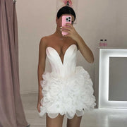 Mannequin Wearing a Stylish White Ruffled Tulle Corset Birthday Dress with Layered Skirt and Structured Bodice, Styled for Luxe Celebrations