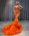Orange feather sequin prom gown with sparkling sequins and elegant feather details.