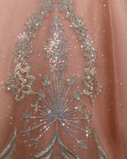 Blush pink glitter quinceañera ball gown with silver appliqués and corset bodice.