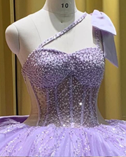 Lilac one shoulder corset ball gown with corset bodice and cloud ruffle hem
