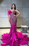 Strapless luxurious mermaid feather floor-length prom gown with elegant fitted design.