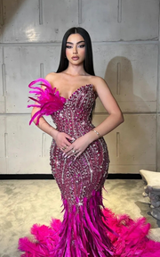 Strapless luxurious mermaid feather floor-length prom gown with elegant fitted design.