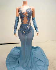 Glitter light blue prom dress with rhinestone mesh and see-through design, styled for formal events and glamorous occasions.