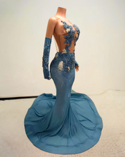 Glitter light blue prom dress with rhinestone mesh and see-through design, styled for formal events and glamorous occasions.