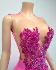 Luxury evening gown with rose rhinestone appliqué and beaded embellishments, styled for formal events and high-glamour occasions.