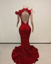 Pamela wearing a glitter red mermaid prom dress for prom night.