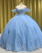 Light blue quinceañera gown with flowing princess-style skirt and fitted bodice.