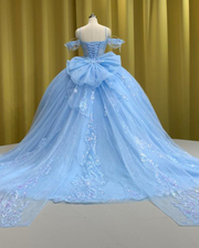 Light blue quinceañera gown with flowing princess-style skirt and fitted bodice.