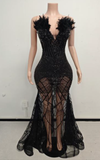 Sequin mermaid gown with deep V neckline and feather-detailed flare