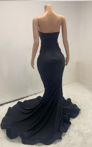 Eden black mermaid evening gown with sheer beaded corset bodice and flowing train for evening events, birthdays, or stage appearances.