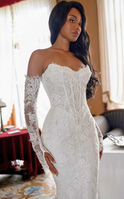 Lace sweetheart mermaid wedding dress with lace appliqués and sweep train for brides.