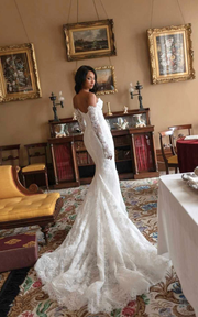 Lace sweetheart mermaid wedding dress with lace appliqués and sweep train for brides.