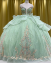 Mint green glitter quinceañera ball gown with rose gold appliqué and crystal corset bodice.