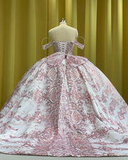 Off shoulder white and rose gold quinceañera ball gown with crystal bodice.