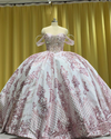 Off shoulder white and rose gold quinceañera ball gown with crystal bodice.
