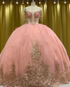 Strapless peach coral glitter quinceañera ball gown with ombre gold sequin appliqués.