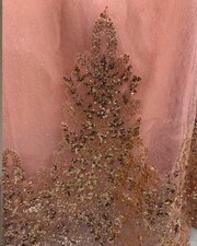 Strapless peach coral glitter quinceañera ball gown with ombre gold sequin appliqués.