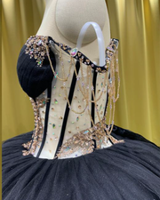 Black quinceañera dress with gold sequin appliqués, fitted bodice, and full princess skirt.