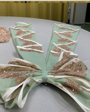 Mint and rose gold quinceañera gown with tulle skirt, rose gold appliqués, and fitted bodice.