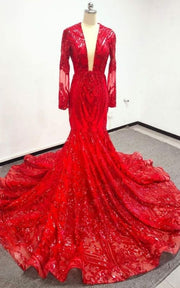 Luxury formal gown featuring illusion sleeves and dramatic train