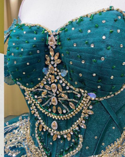 Emerald green off-shoulder princess quinceañera ball gown with corset bodice and full tulle skirt.