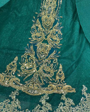 Emerald green off-shoulder princess quinceañera ball gown with corset bodice and full tulle skirt.