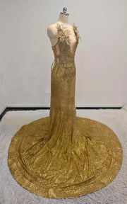Radiant gold sequin mermaid gown with 3D gilded leaf appliqués, illusion plunging neckline, and circular cathedral train