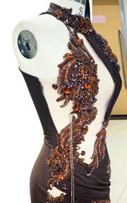 Deep brown mermaid gown with bronze baroque appliqués, asymmetrical cut-outs, and draped halter neckline