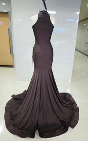 Deep brown mermaid gown with bronze baroque appliqués, asymmetrical cut-outs, and draped halter neckline