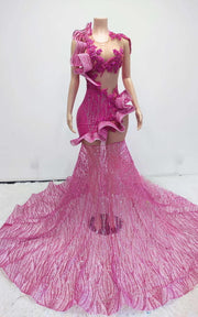 Pink mermaid gown featuring sculptural organza ruffles and a glittering mesh train, fitted silhouette with dramatic flare