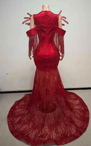 Ruby red beaded mermaid gown with sculptural chest fin details, sequin fringe off-the-shoulder sleeves, and floor-length illusion train